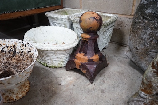 An oval cast iron garden planter, width 39cm, height 20cm together with three reconstituted stone garden planters and a finial